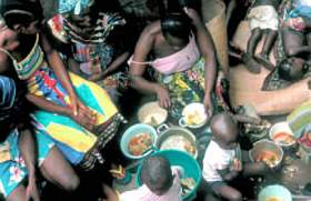 mothers and children around the food bowls